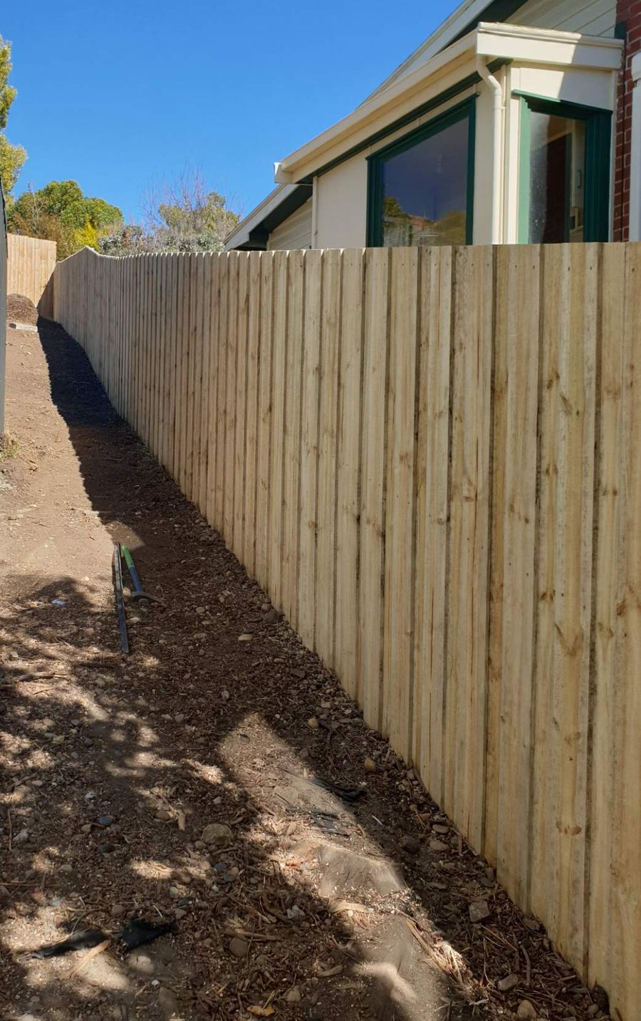 Paling fence along a side path